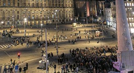 People begin to arrive at a memorial for Russian opposition leader Alexei Navalny at the National Monument on Dam Square in Amsterdam hours after his death at the age of 47. 16 February 2024