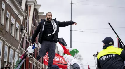 The police intervene after demonstrators climbed onto a van of the Mobile Unit on Waterlooplein.