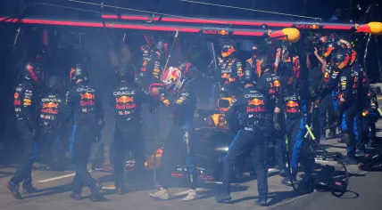 Red Bull Racing's Dutch driver Max Verstappen (C) walks back to the garage after smoke billowing from his car during the Australian Formula One Grand Prix at Albert Park Circuit in Melbourne on March 24, 2024. 