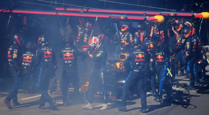 Red Bull Racing's Dutch driver Max Verstappen (C) walks back to the garage after smoke billowing from his car during the Australian Formula One Grand Prix at Albert Park Circuit in Melbourne on March 24, 2024. 