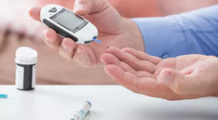 Diabetes. Stock photo of a man measuring his blood sugar levels
