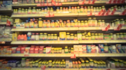 Blurred photo of vitamins, supplements, and natural remedies in a drug store