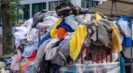 Pile of old clothes dumped in a container