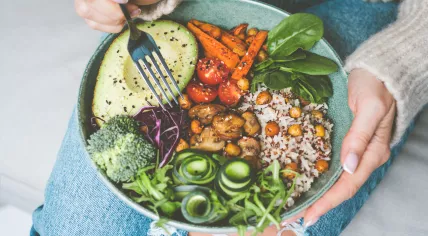Bowl with rice, quinoa, avocado, cucumber, broccoli and cucumber.