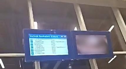 Passengers at Arnhem Centraal Station saw at least one adult film displayed on video screens alongside scheduled bus service updates. 10 April 2024