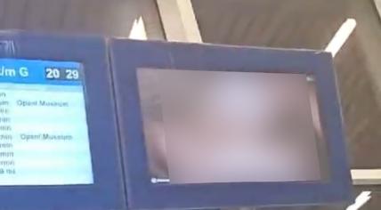 Passengers at Arnhem Centraal Station saw at least one adult film displayed on video screens alongside scheduled bus service updates. 10 April 2024