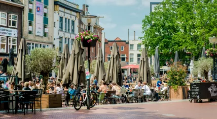  People sitting at outdoors restaurant in the main square of Eindhoven on sunny spring day