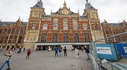 People walk past construction at the central rail station in Amsterdam. April 2024