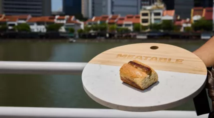 A Meatable lab-grown saussage in a bun at the company's first tasting in Singapore, 3 October 2023