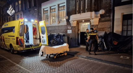 Police and paramedics at the scene of a fatal stabbing at a homeless shelter on Oudezijds Voorburgwal in Amsterdam, 2 April 2024