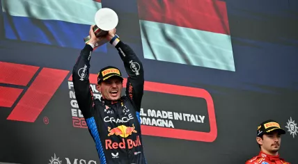 Race winner Red Bull Racing's Dutch driver Max Verstappen holds his trophy as third-placed Ferrari's Monegasque driver Charles Leclerc (R) stands on the podium of the Emilia Romagna Formula One Grand Prix at the Autodromo Enzo e Dino Ferrari race track in Imola on May 18, 2024. 