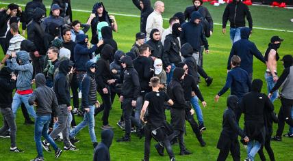 FC Utrecht supporters storm the field during the European football play-offs final between FC Utrecht and Go Ahead Eagles at Galgenwaard stadium on May 26, 2024 in Utrecht, Netherlands.