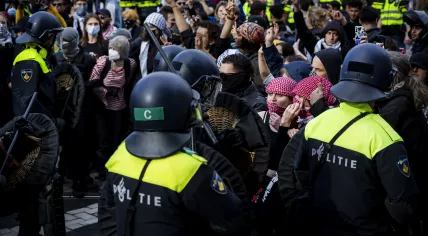 Riot police surround and arrest a group of pro-Palestinian demonstrators trying to reach a pro-Israel protest on Dam Square in Amsterdam, 27 May 2024