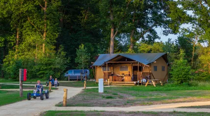 Dalfsen, Neterlands - June 19, 2020: Family enjoying their bungalow tent in the middel of nature at recreation park in the Netherland