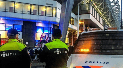 Police watching PSV fans leaving the celebration of their team's 25th Eredivisie title, 6 May 2024