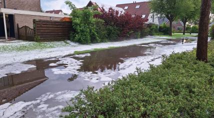 Piles of hail on a flooded street in Achtkarspelen, Friesland. 20 May 2024