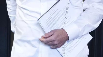 Zoomed in - PVV parliamentarian Gidi Markuszower enters the Cabinet formation talks with the first page of the draft agreement showing, 6 May 2024