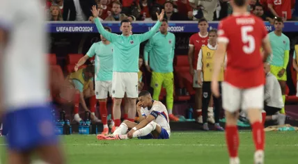 The Austria bench reacts as Kylian Mbappe of France pulls up pausingg play after breaking his nose during the UEFA European Championships match at Dusseldorf Arena, Dusseldorf. 17 June 2024