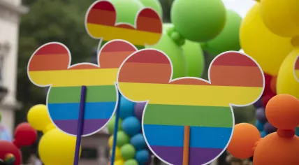 Disney Micky Mouse signs with pride flags at the annual Pride in London, 2019. 