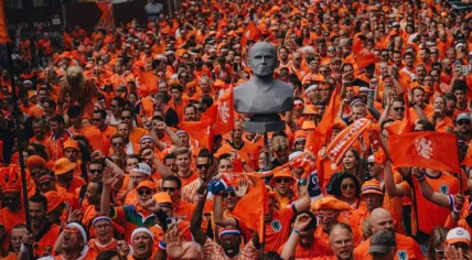 Oranje fans march through the streets of Hamburg toward the Netherlands' first match in the 2024 European Championship against Poland, 16 June 2024