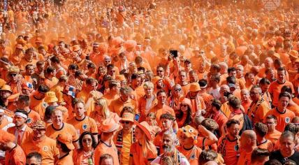 Oranje fans march through the streets of Hamburg toward the Netherlands' first match in the 2024 European Championship against Poland, 16 June 2024