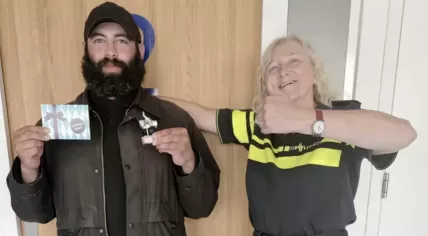 Hadjer Al-Ali, a homeless man in Amsterdam, receives a sliver thumb award from the police for turning in a wallet containing 2,000 euros, 23 June 2024