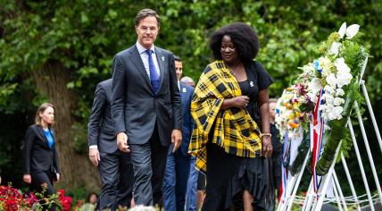 Mark Rutte and Linda Nooitmeer walk past wreathes during the national memorial ceremony about the Dutch history of slavery. 1 July 2024