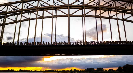 Walkers cross the Waal bridge on the first day of the Vierdaagse marches, 16 July 2024