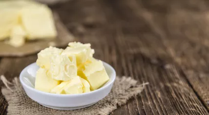 Pieces of Butter on wooden background