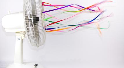 An electric fan with colorful ribbons