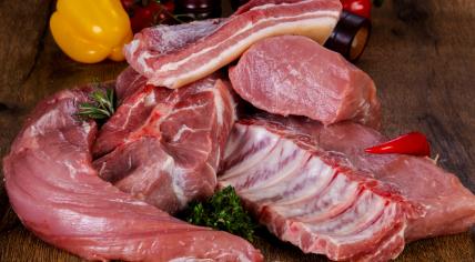 Raw pork over wooden background