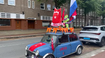 A car deckec with Dutch and Turkish flags ahead of the Netherlands and Turkey's matches in the round of 16 of the European Championship. Parked in front of a mosque in Amsterdam Oost, 2 July 2024