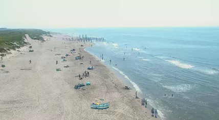 Beachgoers hanging out on the North Sea coast in Petten, Noord-Holland. 18 July 2024