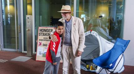 11-year-old Mikael talking to hunger striker Eduard Disch, at the building of the Immigration and Naturalization Service. 