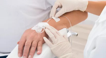 IV drip inserted in a patient's hand