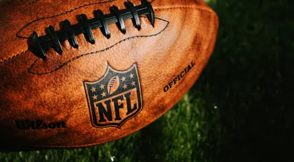 NEW YORK, USA, SEPTEMBER 11, 2023: NFL background photo. Ball placed on green grass in beautiful light.