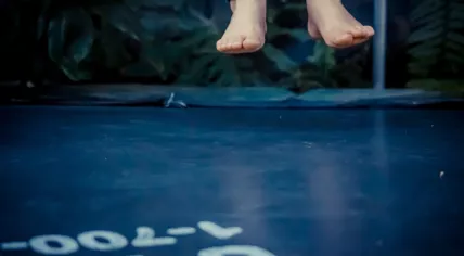 Legs floating in the air after jumping on the trampoline