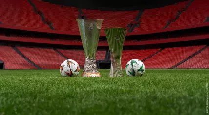 Image of the UEFA Europa League and UEFA Conference League trophies and ball.