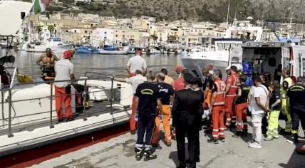 Emergency services crews await the return of divers and victims after a fatal incident where a yacht sank off Porticello in Italy. 19 August 2024