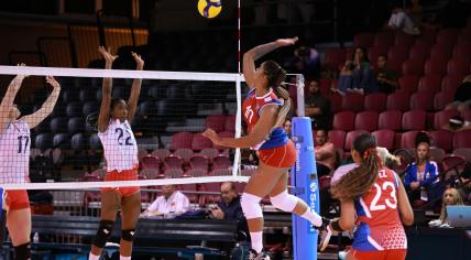 Cuba's Ellemay Tejeda attempts to spike the ball against Costa Rica's 