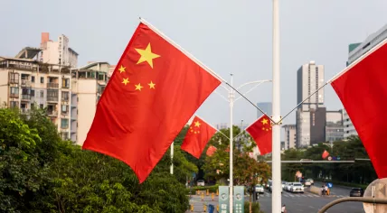 Chinese National flag hanging at the street lamp during holidays in Longgang, Shenzhen, China.