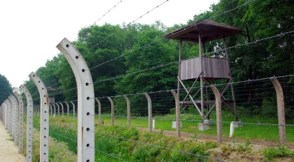 Barbed wire fences and watchtowers from inside Camp Vught.