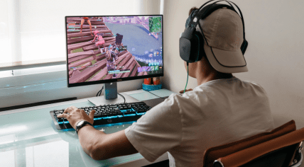 A teenager playing Fortnite on a PC