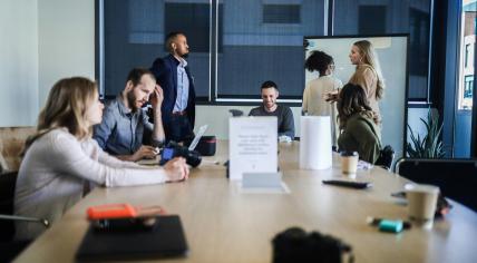 A group of colleagues gathered around a table in 2021