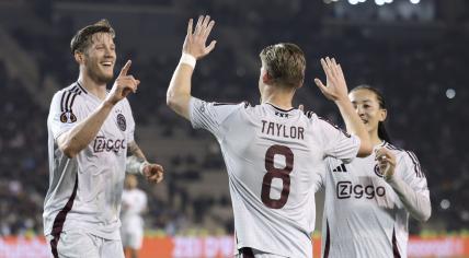 Ajax's Kenneth Taylor, centre, celebrates after scoring his side's opening goal during the Europa League soccer match between Qarabag and Ajax at the Tofiq Bahramov Republican stadium in Baku, Azerbaijan, Thursday, Oct. 24, 