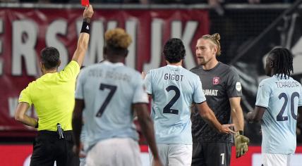 FC Twente goalkeeper Lars Unnerstall receives the red card from referee Nikola Dabanovic during the UEFA Europa League match between FC Twente and S.S Lazio Roma at Stadion De Grolsch Veste on October 24, 2024 in Enschede, Netherlands.