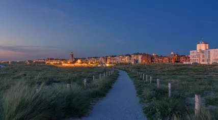 Sunset with the blue hour in Katwijk aan Zee with walking path from the dunes to the boulevard, 11 June 2022