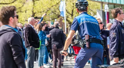An enforcement officer in a crowd in Amsterdam