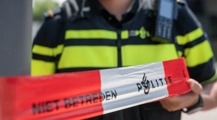 Police officer cordoning off a crime scene