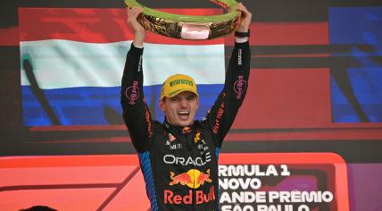 Red Bull Racing's Dutch driver Max Verstappen celebrates at the podium with the trophy of the Formula One Sao Paulo Grand Prix, at the Jose Carlos Pace racetrack, aka Interlagos, in Sao Paulo, Brazil, on November 3, 2024. 